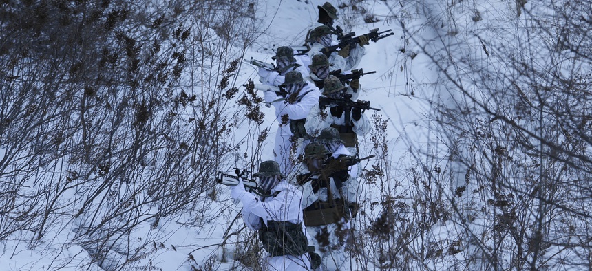 In this Tuesday, Dec. 19, 2017, file photo, South Korean and U.S. Marines from III-Marine Expeditionary Force from Okinawa, Japan, patrol on the snow during their joint military winter exercise in Pyeongchang, South Korea.
