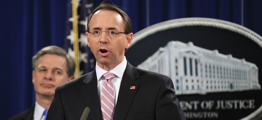 Deputy Attorney General Rod Rosenstein with FBI Director Christopher Wray, speaks during a news conference at the Department of Justice in Washington, Thursday, Dec. 20, 2018.