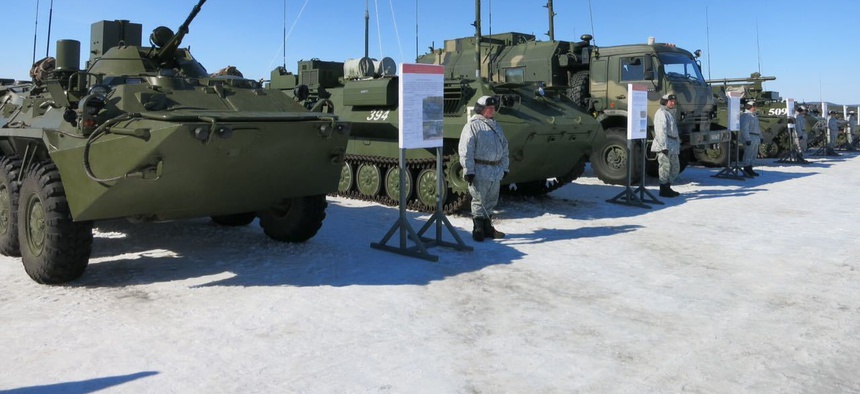 In this photo taken on Tuesday, April 25, 2017, soldiers of the Arctic motorised rifle brigade of Russia's Northern Fleet took stand near APCs during military exercise in Alakyrtti, Murmansk region, Russia.