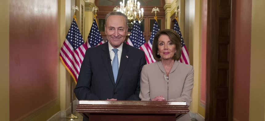 Senate Minority Leader Chuck Schumer of N.Y., and House Speaker Nancy Pelosi of Calif., pose for photographers after speaking on Capitol Hill in response President Donald Trump's address, Tuesday, Jan. 8, 2019.
