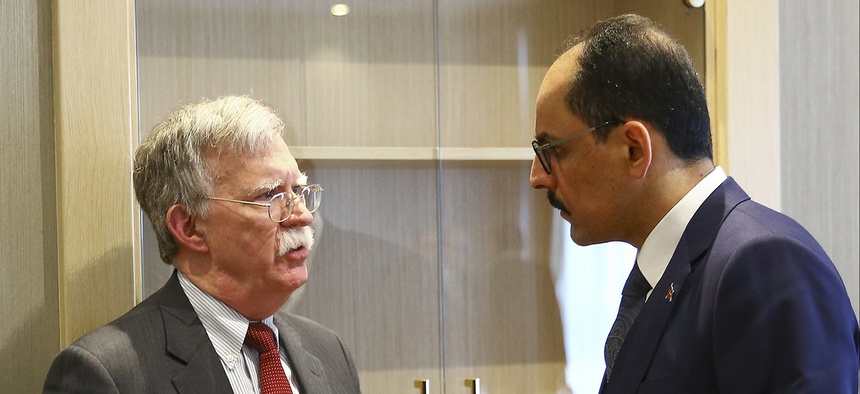 U.S. National Security Adviser John Bolton, left, and his Turkish counterpart and senior adviser to President Recep Tayyip Erdogan, Ibrahim Kalin, right, talk at the Presidential Palace in Ankara, Turkey, Tuesday, Jan. 8, 2019.