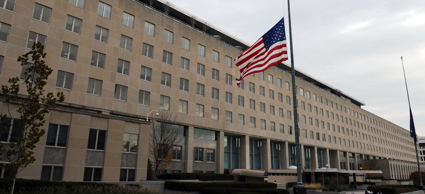 The U.S. flag flies hang at half-staff at the U.S. Department of State in Washington, D.C., on November 22, 2013.