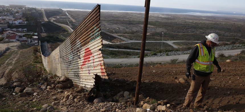 Stewart Williams works with a crew removing border to be replaced with new border wall Wednesday, Jan. 9, 2019, seen from Tijuana, Mexico.