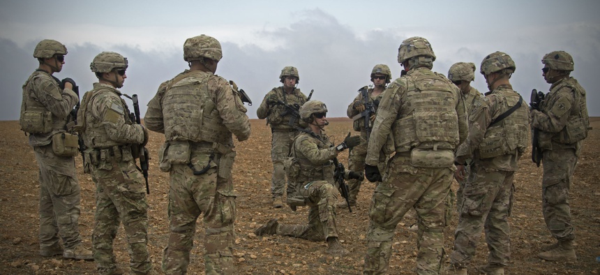 U.S. soldiers gather for a brief during a combined joint patrol rehearsal in Manbij, Syria, Nov. 7, 2018.