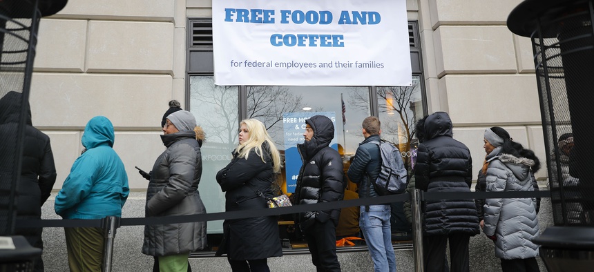 People wait in line at Chef Jose Andres' World Central Kitchen for free meals to workers effected by the government shutdown in Washington, Wednesday, Jan. 16, 2019.