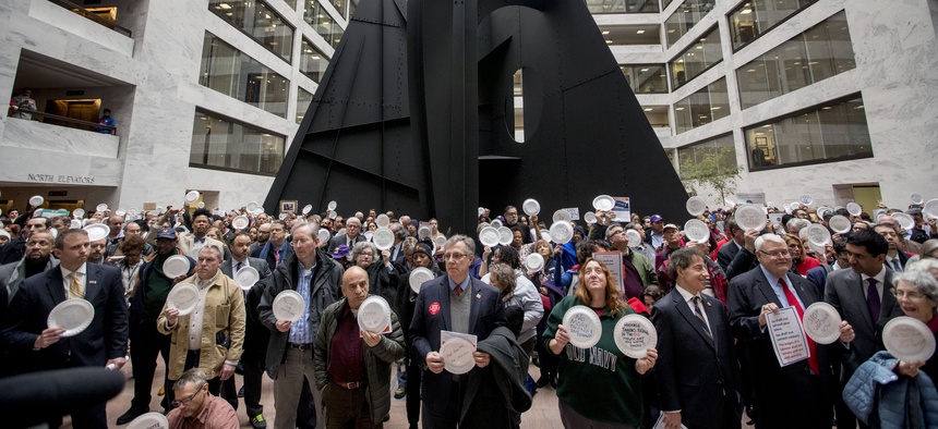 Furloughed government workers affected by the shutdown hold a silent protest against the ongoing partial government shutdown on Capitol Hill in Washington, Wednesday, Jan. 23, 2019.