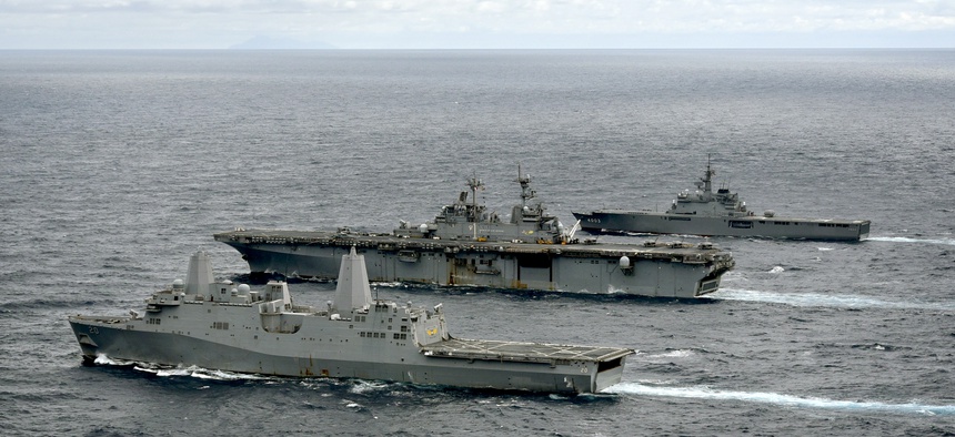 The amphibious transport dock ship USS Green Bay (LPD 20), left, amphibious assault ship USS Wasp (LHD 1), and Japan Maritime Self-Defense Force amphibious transport dock ship JS Kunisaki (LST 4003) transit in formation during a cooperative deployment.