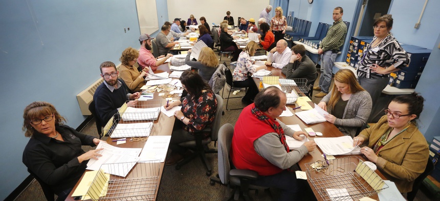 Ballots are recounted in Maine's 2nd Congressional District, Thursday, Dec. 6, 2018, in Augusta, Maine.