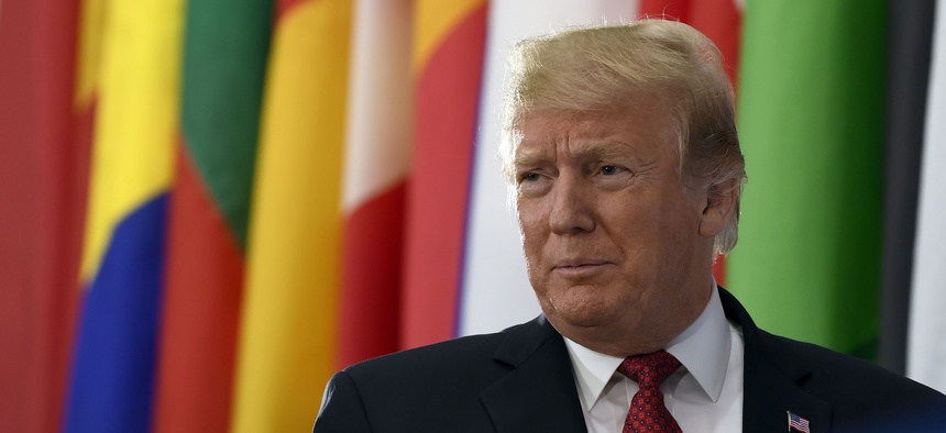 President Donald Trump walks on stage to speak at the Global Coalition to Defeat ISIS meeting at the State Department in Washington, Wednesday, Feb. 6, 2019