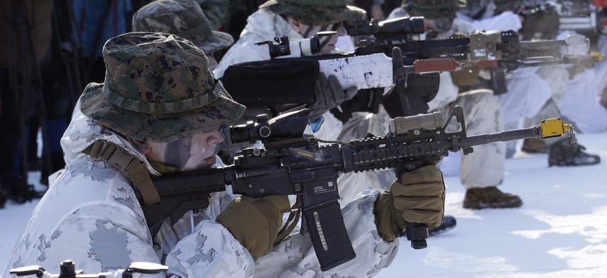 South Korean and U.S. Marines from III Marine Expeditionary Force from Okinawa, Japan, fire their machine guns during their joint military winter exercise in Pyeongchang, South Korea, Tuesday, Dec. 19, 2017.