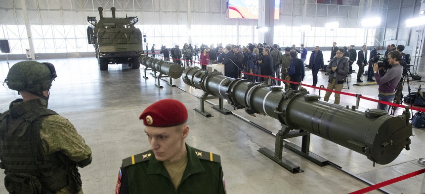Russian military officers stand by as the 9M729, center, its launcher, left, and the 9M728, right, land-based cruise missiles are displayed in Kubinka outside Moscow, Russia, Wednesday, Jan. 23, 2019.