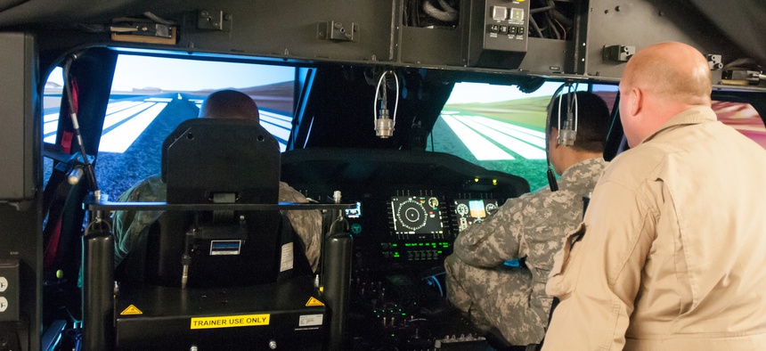 Pilots assigned to the 25th Combat Aviation Brigade, 25th Infantry Division, receive their first look and hands-on-experience with the new UH-60M Black Hawks on the Transportable Black Hawk Operations Simulator, Jan. 14, 2014.