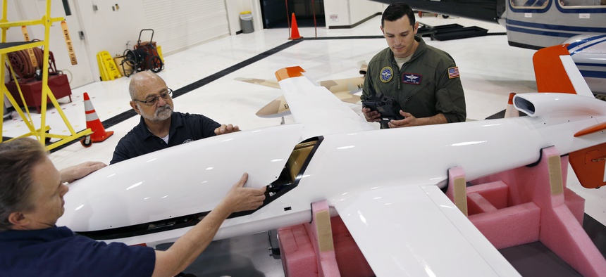In this May 19, 2016, photo, Joe Cummings, from left, Mike Lukens and Mike Toland, of National Security Technologies, a contractor for the National Nuclear Security Administration, work on a drone at the Remote Sensing Laboratory in Las Vegas.
