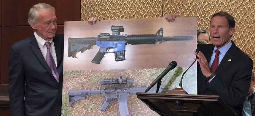 Sen. Edward Markey, D-Mass., left, and Sen. Richard Blumenthal, D-Ct., display a photo of a plastic gun on Tuesday, July 31, 2018, on Capitol Hill in Washington.