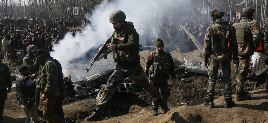 In this Wednesday, Feb.27, 2019 file photo, Indian army soldiers arrive at the wreckage of an Indian helicopter after it crashed killing several in the Budgam area, on the outskirts of Srinagar, Indian controlled Kashmir.
