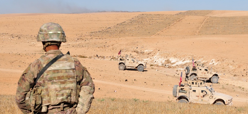 U.S. Soldiers observe Turkish forces in the distance during a patrol outside Manbij, Syria, Aug. 19, 2018.