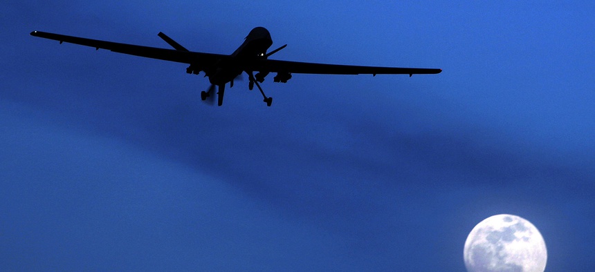 In this Jan. 31, 2010, file photo, an unmanned U.S. Predator drone flies over Kandahar Air Field, southern Afghanistan, on a moon-lit night.