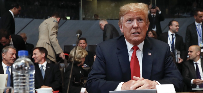 President Donald Trump takes his seat as he attends the multilateral meeting of the North Atlantic Council, Wednesday, July 11, 2018 in Brussels, Belgium.