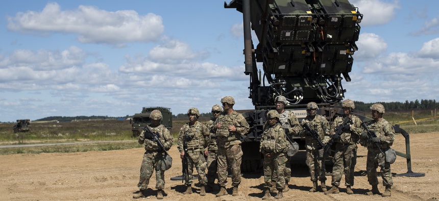 Members of US 10th Army Air and Missile Defense Command stands next to a Patriot surface-to-air missile battery during the NATO exercise "Tobruq Legacy 2017" at the Siauliai airbase near Vilnius, Lithuania, July 20, 2017.