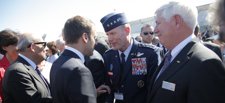 French President Emmanuel Macron, meets with Gen Tod D. Wolters, commander of the US Air Forces in Europe, 2nd right, while visiting the Paris Air Show in Le Bourget, north of Paris, Monday, June 19, 2017.
