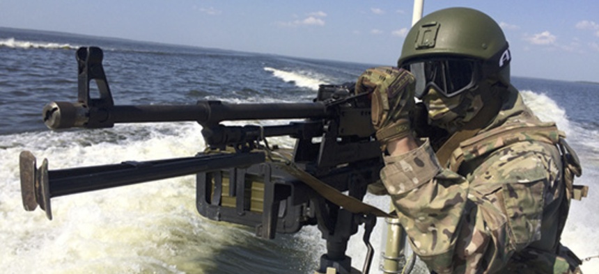 In this handout frame grab released on Thursday, Sept. 20, 2018 by Russian Defense Ministry Press Service, a Russian serviceman aims a machine-gun during the Russia's Baltic Fleet military exercises.