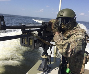 In this handout frame grab released on Thursday, Sept. 20, 2018 by Russian Defense Ministry Press Service, a Russian serviceman aims a machine-gun during the Russia's Baltic Fleet military exercises. In this handout frame grab released on Thursday, Sept. 20, 2018 by Russian Defense Ministry Press Service, a Russian serviceman aims a machine-gun during the Russia's Baltic Fleet military exercises.