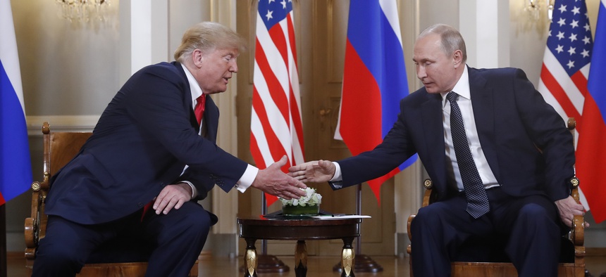 U.S. President Donald Trump, left, and Russian President Vladimir Putin shake hand at the beginning of a meeting at the Presidential Palace in Helsinki, Finland, Monday, July 16, 2018.
