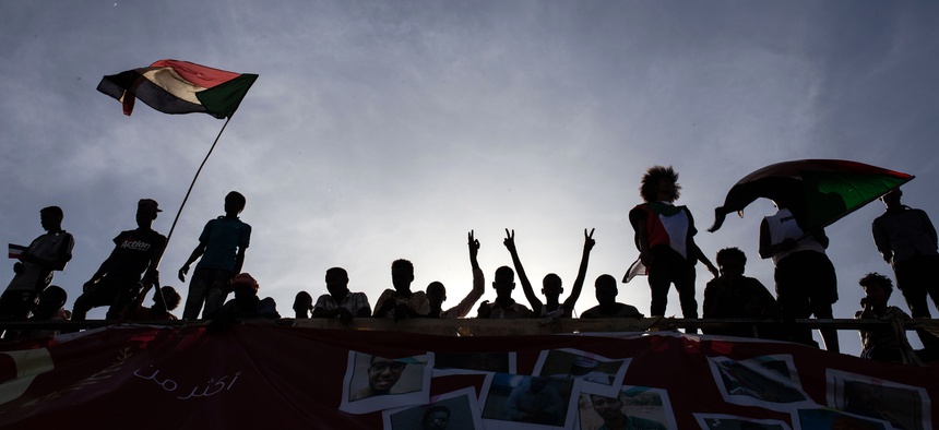 Demonstrators rally near the military headquarters in Khartoum, Sudan, Monday, April 15, 2019.