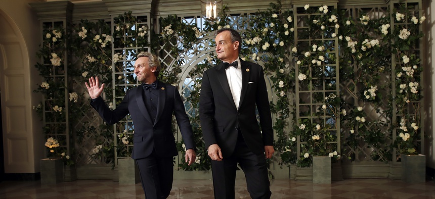 Pascal Blondeau, left, and Gérard Araud, Ambassador of France to the United States, arrive for a State Dinner with French President Emmanuel Macron and President Donald Trump at the White House, Tuesday, April 24, 2018, in Washington.
