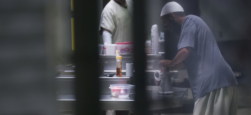 In this photo reviewed by U.S. military officials, detainees stand inside the Camp VI detention facility, Wednesday, April 17, 2019, in Guantanamo Bay Naval Base, Cuba.