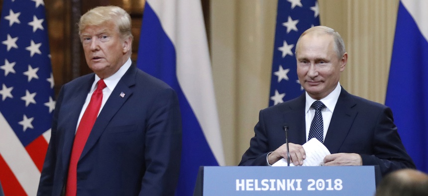 In this July 16, 2018, file photo, U.S. President Donald Trump, left, and Russian President Vladimir Putin arrive for a press conference after their meeting at the Presidential Palace in Helsinki, Finland.