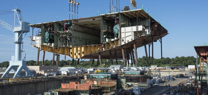 Newport News Shipbuilders lifted a 704-metric-ton aunit into Dry Dock 12, where construction of the aircraft carrier USS John F. Kennedy (CVN-79) is taking shape.