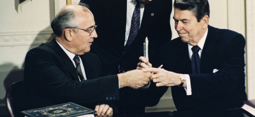 In this Dec. 8, 1987, file photo U.S. President Ronald Reagan, right, and Soviet leader Mikhail Gorbachev exchange pens during the Intermediate Range Nuclear Forces Treaty signing ceremony in the White House East Room in Washington, D.C.