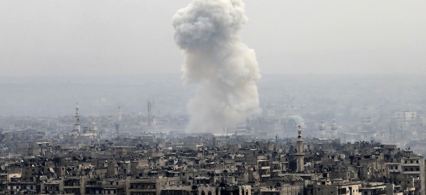 Smoke rises following a Syrian government air strike on rebel positions, in eastern Aleppo, Syria, Monday, Dec. 5, 2016.