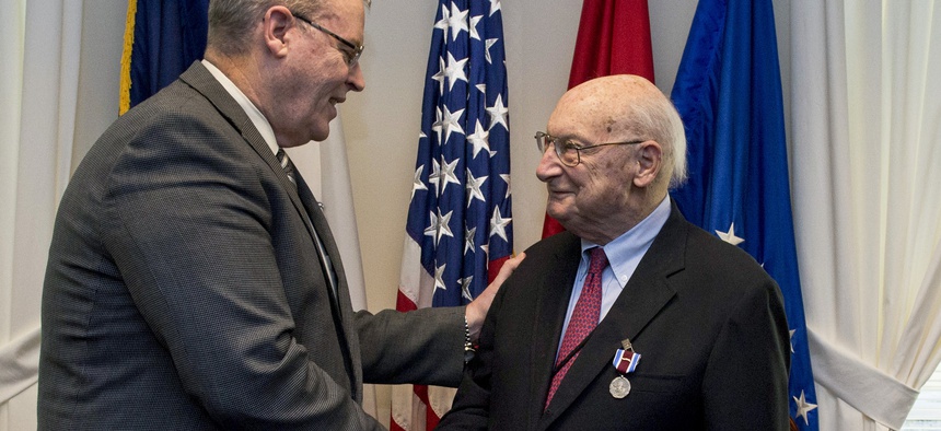 Deputy Defense Secretary Bob Work hosts a farewell ceremony for Andrew M. Marshall at the Pentagon, Jan. 5, 2015. Marshall, 93, worked his last day as director of the Defense Department's Office of Net Assessment, retiring after 42 years.