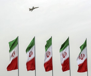 A fighter jet flies over Iranian flags during the army parade commemorating National Army Day in front of the shrine of the late revolutionary founder Ayatollah Khomeini, just outside Tehran, Iran, Thursday, April 18, 2019.