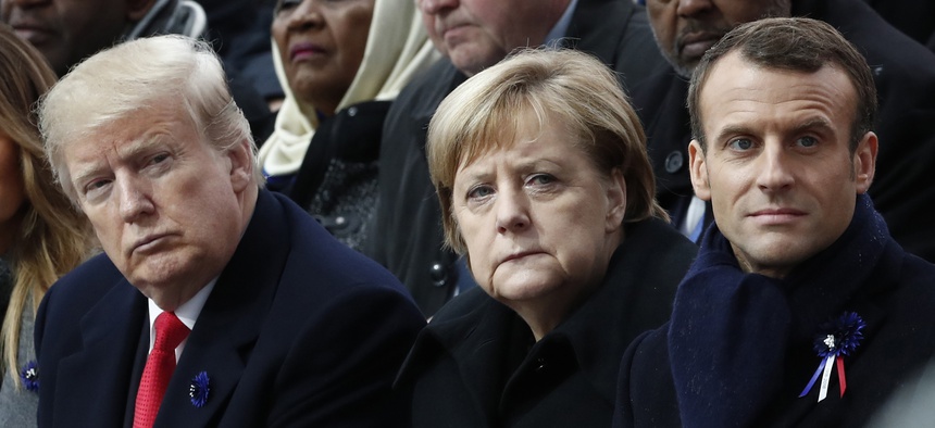 French President Emmanuel Macron, German Chancellor Angela Merkel and President Donald Trump attend a commemoration ceremony for Armistice Day at the Arc de Triomphe in Paris, France, Nov. 11, 2018.