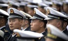 Chinese sailors sit before the start of a concert featuring Chinese and foreign military bands in Qingdao, Monday, April 22, 2019.