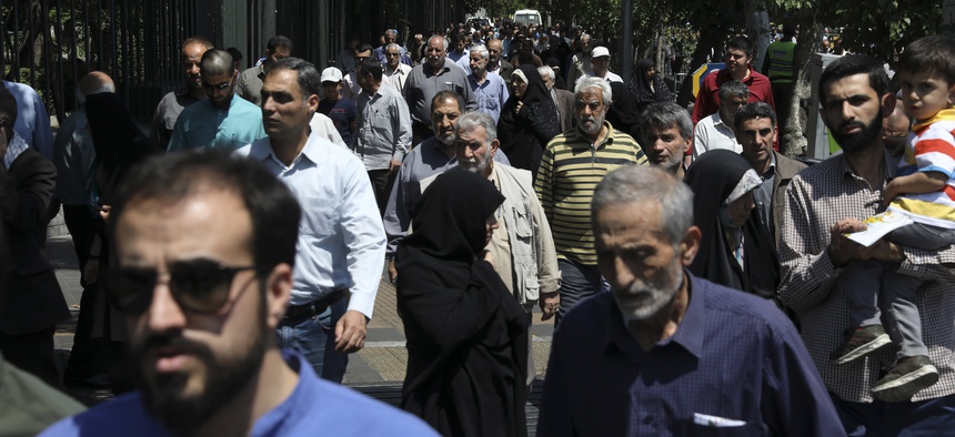 In this Friday, May 17, 2019 photo, worshippers leave at the conclusion of Friday prayers in downtown Tehran, Iran.