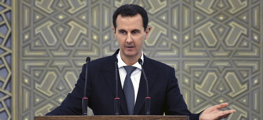 In this photo released by the Syrian official news agency SANA, Syrian President Bashar Assad speak during meeting with heads of local councils from all Syrian provinces, in Damascus, Syria, Sunday, Feb. 17, 2018.