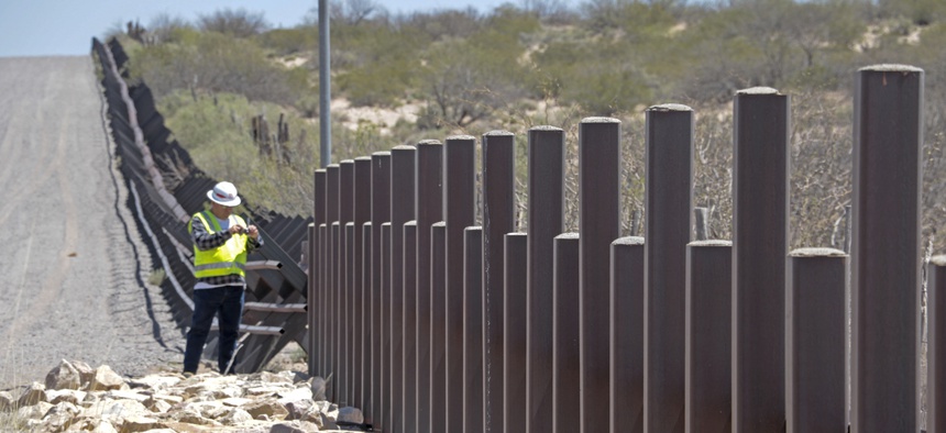 A U.S. Army Corps of Engineers employee inspects existing vehicle barrier near Columbus, New Mexico, April 11.