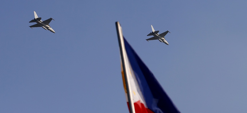 Two of the Philippines' KA-50 fighter jets fly over Manila in this 2015 photo.