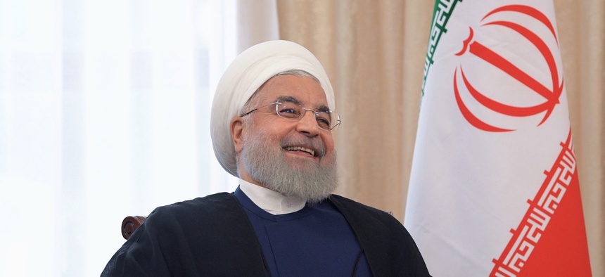 Iranian President Hassan Rouhani smiles as he speaks to Russian President Vladimir Putin during their talks on a sideline of the Shanghai Cooperation Organization summit in Bishkek, Kyrgyzstan, Friday, June 14, 2019.