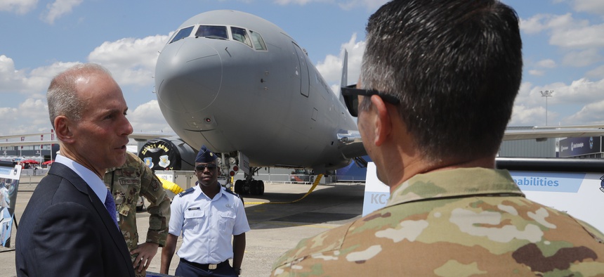 Boeing Chief Executive Dennis Muilenburg speaks to a crew member of a Boeing KC-46 taker at the Paris Air Show, in Le Bourget, outside Paris, France, on June 17, 2019.