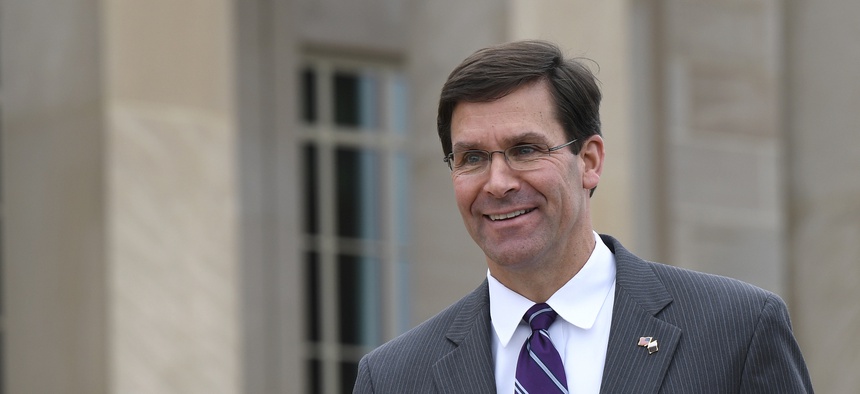 In this July 8, 2019, photo, acting Secretary of Defense Mark Esper waits for the arrival of Qatar's Emir Sheikh Tamim bin Hamad Al Thani to the Pentagon.