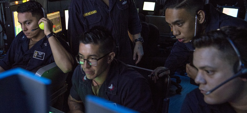 GULF OF ADEN (July 2, 2019) Sailors assigned to amphibious assault ship USS Boxer (LHD 4) observe flight operations on the display of an OD-220 radar from inside the amphibious air traffic control center.
