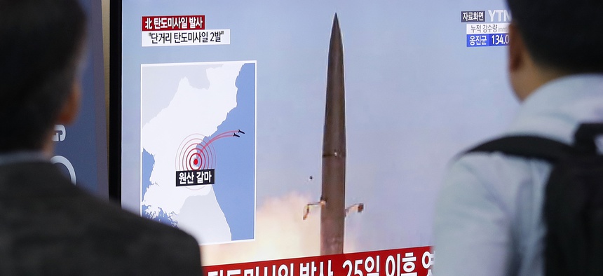 People watch a TV showing a file image of North Korea's missile launch during a news program at the Seoul Railway Station in Seoul, South Korea, Wednesday, July 31, 2019.