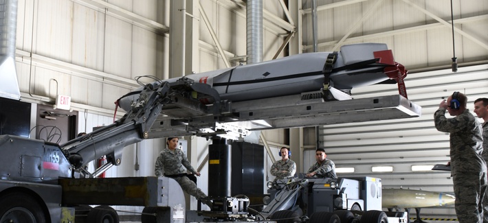 Load crew members from the 28th Munitions Squadron use a munitions lift truck or âjammerâ, to load an inert AGM-158 Joint Air-to-Surface Standoff Missile into a simulated B-1 bomber.