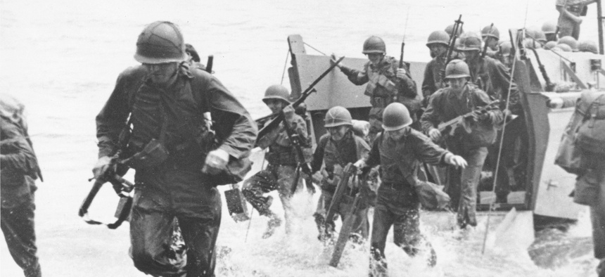 In this Aug. 1942 file photo, U.S. Marines charge ashore on Guadalcanal Island from a landing barge during the early phase of the U.S. offensive in the Solomon Islands during World War II.