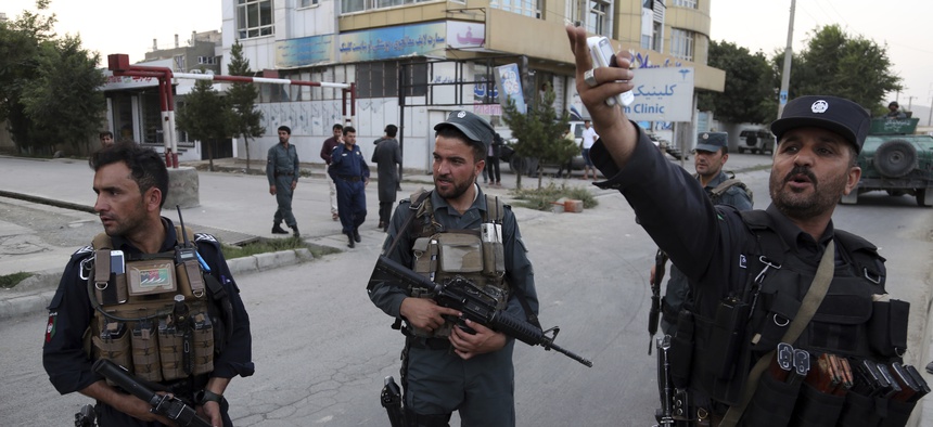 Afghan security personnel secure the site of a deadly attack in Kabul, Afghanistan, Sunday, July 28, 2019.